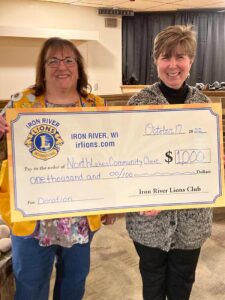 Iron River Lions Donate $1,000 to the Northlakes Community Clinic. Pictured from the left are Reba Rice, CEO, NorthLakes Community Clinic and Anne Madison Iron River Lions Club secretary.