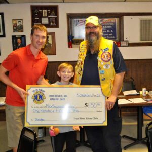 The Iron River Lions Club donated $150 to the Northwoods Circus. The Northwoods Circus offers circus skills classes to anyone ages 10+. Pictured accepting the donation are Bob Evans & Shayden Bradley representing the Northwoods Circus and Chris Olsen President of the Iron River Lions.