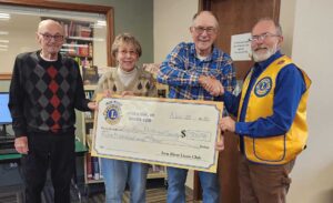 The Iron River Lions Club made their annual donation to the Iron River Wisconsin - Western Bayfield County Historical Society. Presenting the check is Tom Madison, President, Iron River Lions Club. Receiving the donation are members of the Historical Society - Lyle, Linda Hultman, and Dick Rewalt.