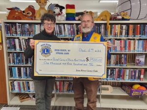 The Iron River Lions Club made their annual donation to the Rural Care and Share Food Shelf. Presenting the check is Tom Madison, President, Iron River Lions Club. Receiving the donation is Sue Masterson representing the Rural Care and Share Food Shelf.